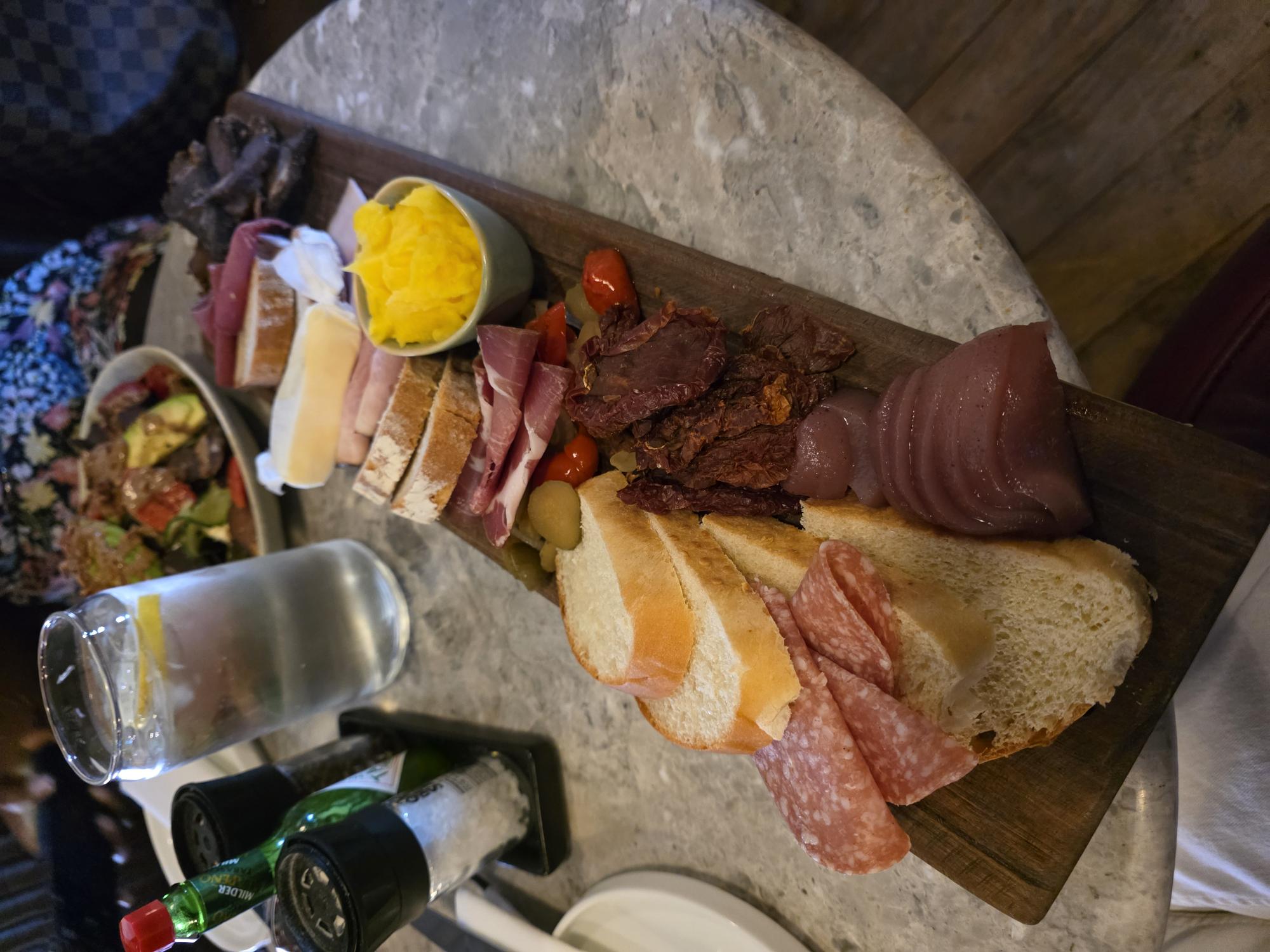 Shared charcuterie board over a long lunch
